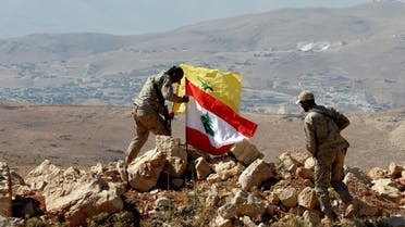 Hezbollah fighters put Lebanese and Hezbollah flags at Juroud Arsal, Syria-Lebanon border, on July 25, 2017. (Reuters)