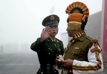 This July 10, 2008 file shows a Chinese soldier (L) next to an Indian soldier at the Nathu La border crossing between India and China in India’s northeastern Sikkim state. (AFP)