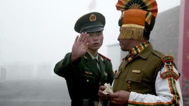 This July 10, 2008 file shows a Chinese soldier (L) next to an Indian soldier at the Nathu La border crossing between India and China in India’s northeastern Sikkim state. (AFP)