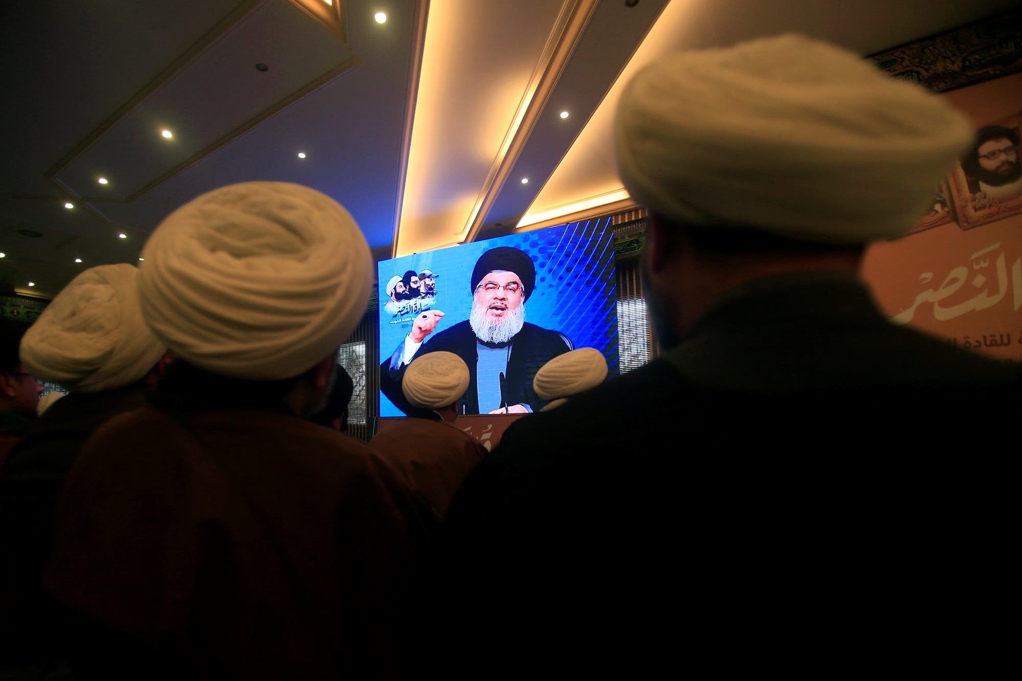 Hassan Nasrallah addresses his supporters through a screen during a rally in Jebshit village, southern Lebanon, on February 16, 2017. (Reuters)