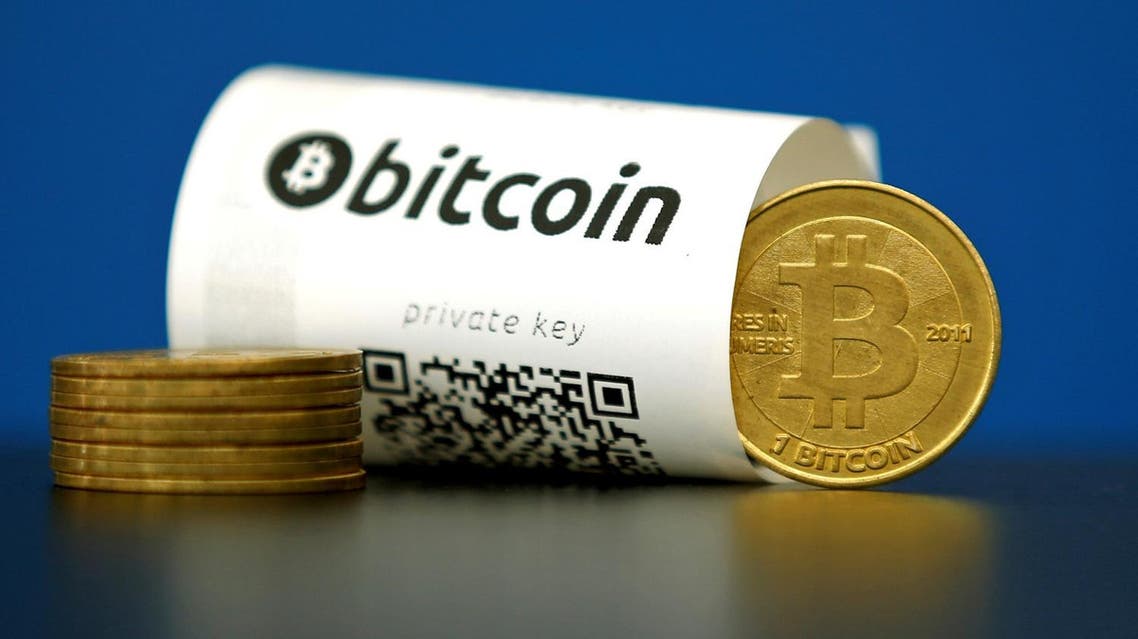 A Bitcoin paper wallet with QR codes and a coin are seen in an illustration picture taken at La Maison du Bitcoin in Paris, France, May 27, 2015. (Reuters)