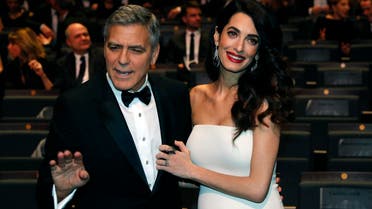 Actor George Clooney and his wife Amal pose before the start of the 42nd Cesar Awards ceremony in Paris, France, February 24, 2017. REUTERS/Philippe Wojazer 