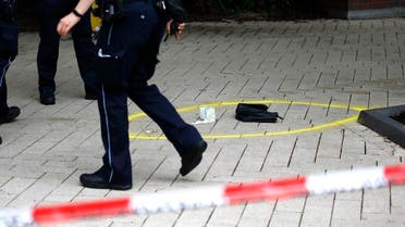 A police officer walks past crime scene after a knife attack in a supermarket in Hamburg. (Reuters)
