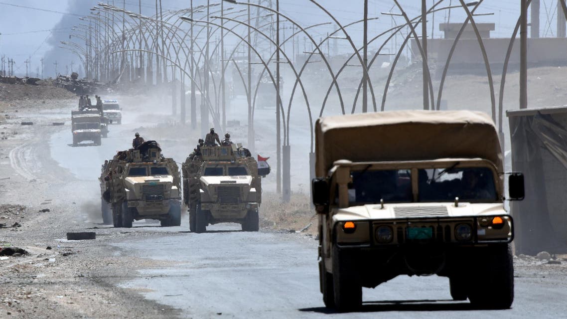Iraqi government forces drive on a road leading to Tal Afar on June 9, 2017, during ongoing battles to retake the city from Islamic State (IS) group fighters.