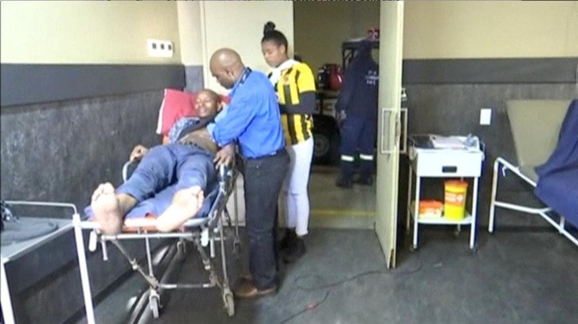 A man who was injured during a stampede at South Africa's FNB Stadium is attended to by paramedics in Soweto, Johannesburg. (Reuters)