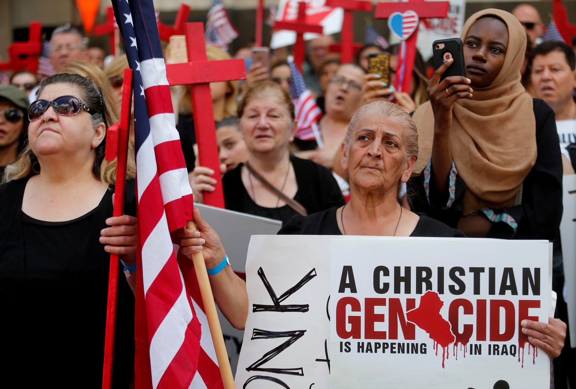 Protesters rally outside the federal court just before a hearing to consider a class-action lawsuit filed on behalf of Iraqi nationals facing deportation, in Detroit, Michigan, US, June 21, 2017. (Reuters)
