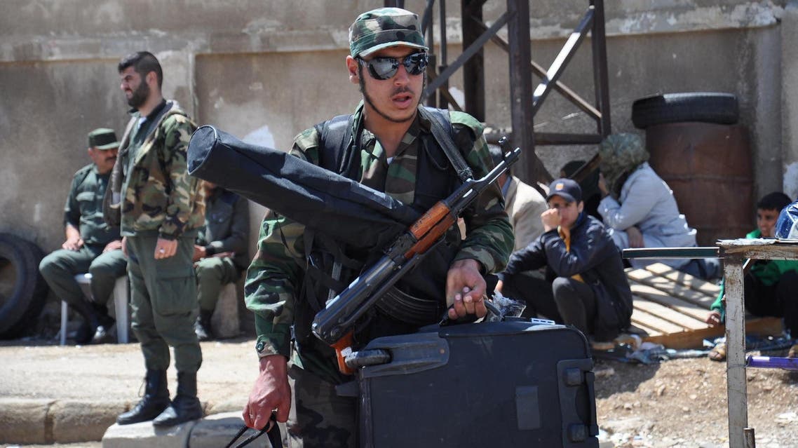 A Syrian opposition fighter arrives at a checkpoint manned by regime forces ahead of his evacuation from the central city of Homs, on May 21, 2017. (AFP)
