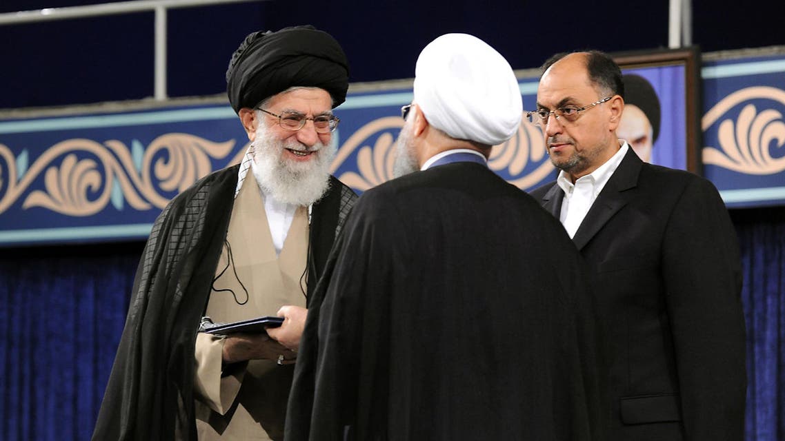 A handout picture released by the official website of the Iranian supreme leader Ayatollah Ali Khamenei shows him (L) giving his official seal of approval during the swearing in ceremony of President Hassan Rouhani (R), as deputy chief of supreme leader's office Vahid Haghanian (C) looks on in Tehran on August 3, 2017. Rouhani vowed to continue his efforts to end the country's isolation as he was sworn in by supreme leader Ayatollah Ali Khamenei to serve his second term following his re-election in May. HO / IRANIAN SUPREME LEADER'S WEBSITE / AFP