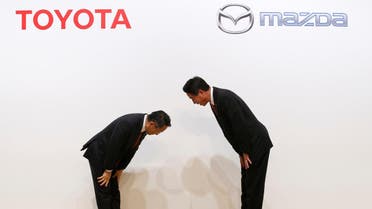 Toyota Motor President Akio Toyoda and Mazda Motor President Masamichi Kogai bow at a joint news conference in Tokyo, Japan August 4, 2017. REUTERS