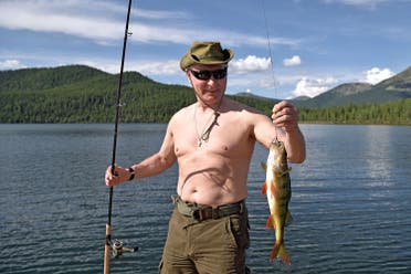 Putin holds a fish he caught during the hunting and fishing trip in the republic of Tyva in southern Siberia, Russia, (Reuters)