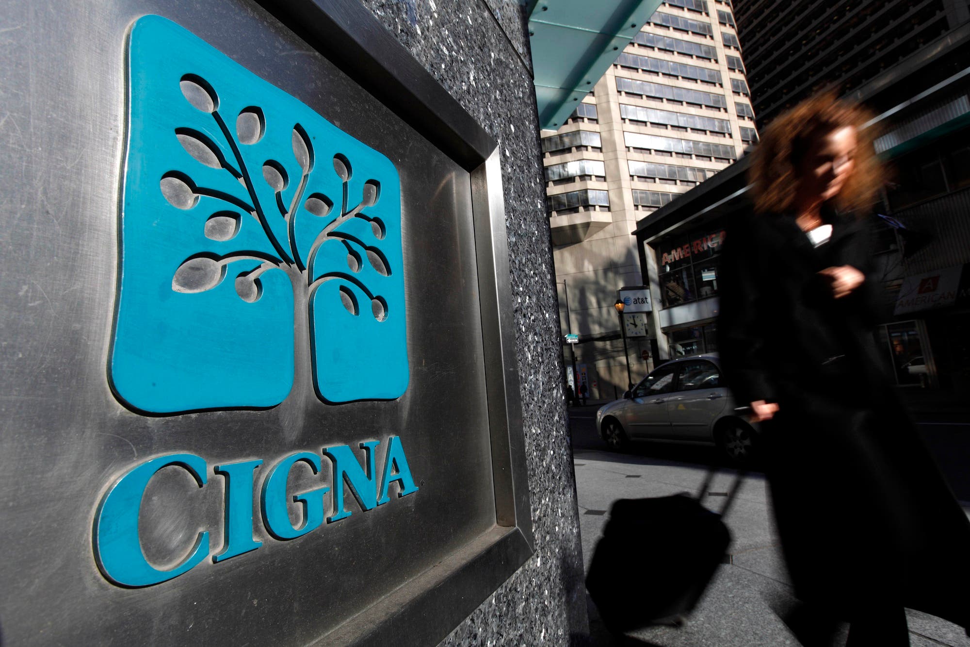A pedestrian walks past the headquarters of the health insurer Cigna Corp. in Philadelphia on Nov. 17, 2009. (AP)