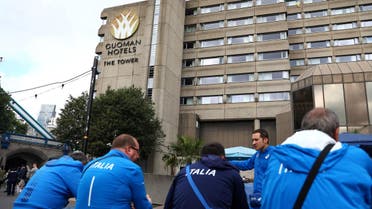 Members of Italy's athletics squad eat outside the Tower Hotel in London. (Reuters) 
