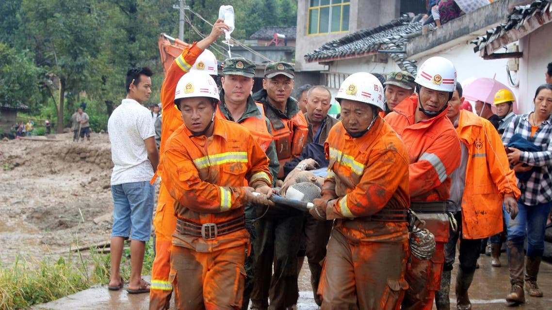 Rescue workers carry an injured villager at the site of a landslide that occurred in Gengdi village, Puge county, Sichuan province, China, on  August 8, 2017. (Reuters)