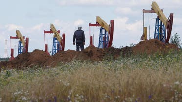 A worker stands in front of pump jacks at the Ashalchinskoye oil field owned by Russia’s oil producer Tatneft near Almetyevsk, in the Republic of Tatarstan, Russia, July 27, 2017. (Reuters)