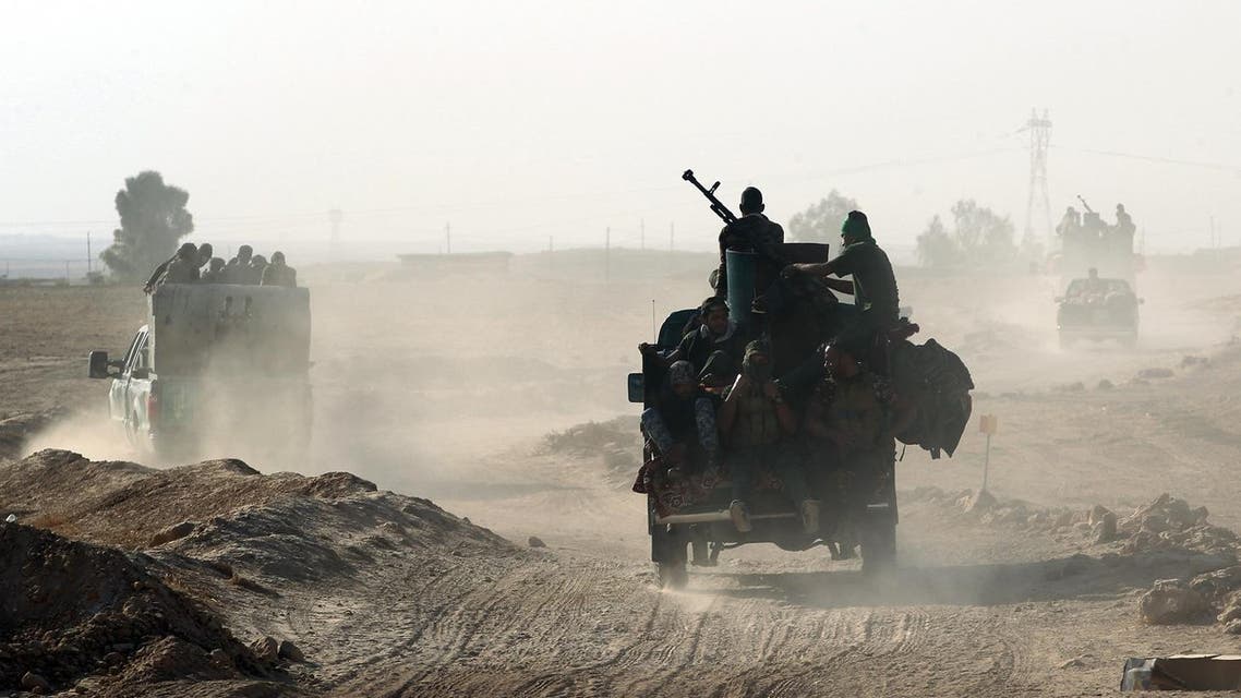 Shiite fighters from the Popular Mobilization Forces arrive in an area south of Mosul, on October 22, 2016, during an operation to retake the main hub city from the Islamic State (IS) group jihadists. Mosul is the most populous city in the "caliphate" Baghdadi declared in June 2014, and the operation to recapture it is Iraq's largest in years.