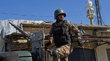 A Pakistani soldier stands guard on an army vehicle at the site of a court complex after multiple Taliban suicide bombings in the Tangi area of Charsadda district on February 21, 2017. At least five people were killed when multiple Taliban suicide bombers attacked a court complex in Pakistan on February 21, officials said, the latest in a series of assaults which have raised fears militants are regrouping. ABDUL MAJEED / AFP
