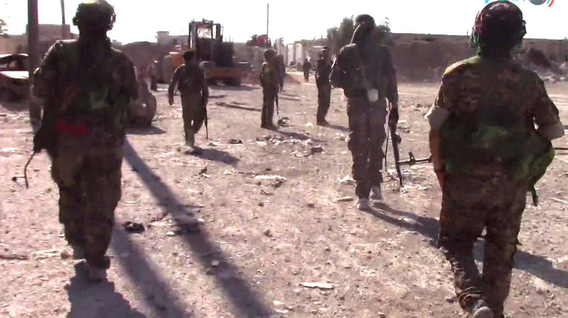 This frame grab from video released on Friday, Aug. 11, 2017 by Furat FM, shows US-backed Syrian Democratic Forces (SDF) fighters advance in Raqqa, Syria. (AP)