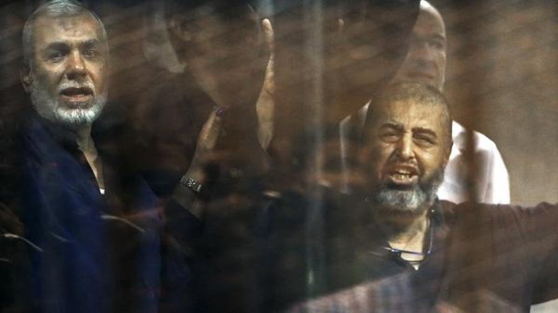 Muslim Brotherhood members gesture behind bars after their verdict at a court on the outskirts of Cairo, Egypt June 16, 2015. (Reuters)