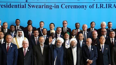Iranian President Hassan Rouhani waves as he poses for a picture with leaders and officials during his swearing-in ceremony for a further term, at the parliament in Tehran. (Reuters)
