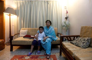 Rehana Khursheed Hashmi, 75, migrated from India with her family in 1960 and whose relatives, live in India, sits with her five year-old grandson Faraz Hashmi, at her residence in Karachi, Pakistan August 7, 2017. (Reuters)