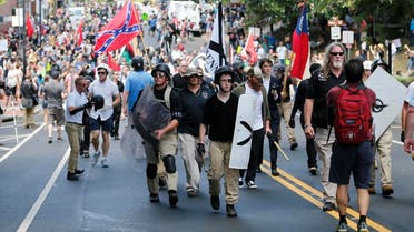 White nationalist demonstrators walk through town after their rally was declared illegal near Lee Park in Charlottesville, Virginia. (AP)