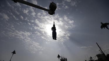 The body of Yemeni Hussein al-Saket, 22, is seen hanging after being executed by security forces for raping and murdering a four-year-old girl, in the capital Sanaa's Tahrir Square, on August 14, 2017. (AFP)