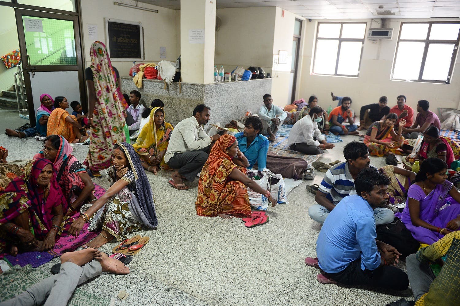 Relatives of patients wait outside the encephalitis ward at the Baba Raghav Das Hospital in Gorakhpur on August 14, 2017. (AFP)