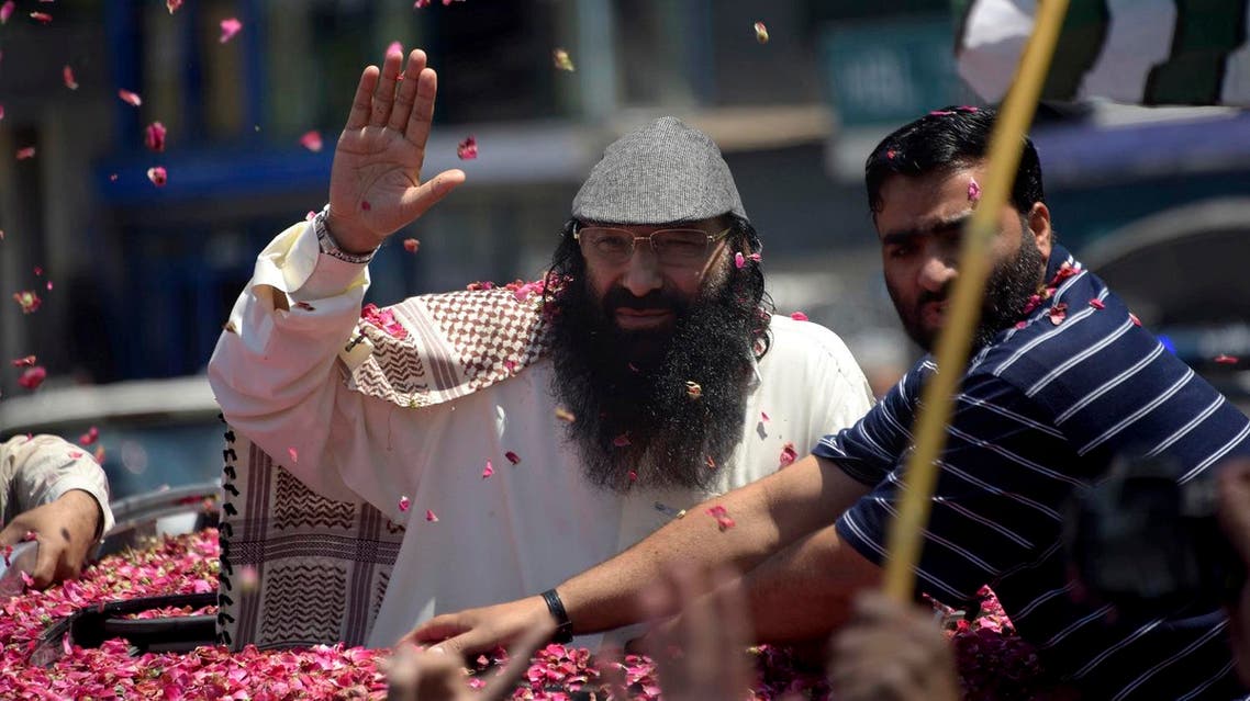 Syed Salahuddin (center), top leader of the Hizbul Mujahideen, waves to his supporters upon his arrival for a press conference in Muzaffarabad, the capital of Pakistani controlled Kashmir. (AP)