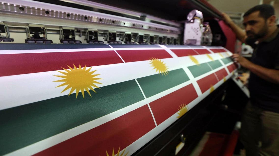 An Iraqi man prints a flag of Kurdistan, in Arbil, the capital of the autonomous Kurdish region of northern Iraq, on June 8, 2017. Iraq's autonomous Kurdish region will hold a historic referendum on statehood in September, despite opposition to independence from Baghdad and possibly beyond. (AFP)