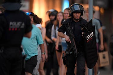 Spanish policemen stand guard in a cordoned off area after a van ploughed into the crowd, killing 13 persons and injuring over 50 on the Rambla in Barcelona on August 17, 2017. A driver deliberately rammed a van into a crowd on Barcelona's most popular street on August 17, 2017 killing at least 13 people before fleeing to a nearby bar, police said. AFP