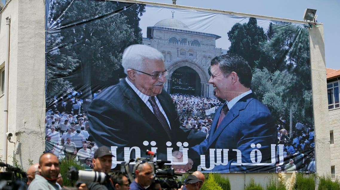 A photo of Jordan's King Abdullah II and Palestinian president Mahmud Abbas shaking hands in front of the Al-Aqsa mosque during a welcome ceremony of the King in Ramallah on August 7. (AFP)