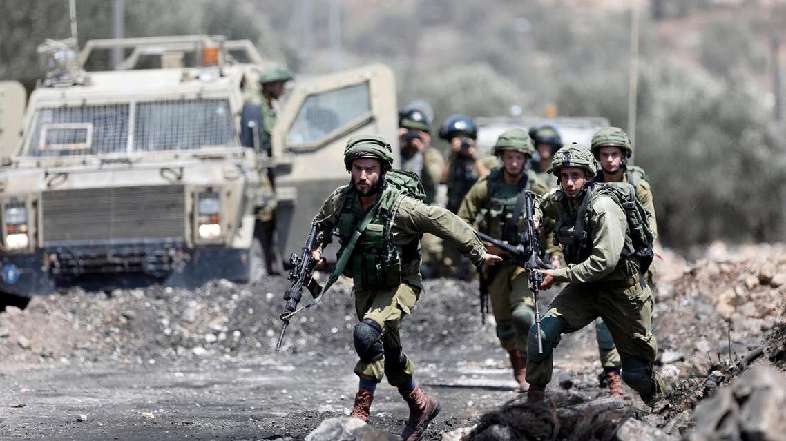 Israeli soldiers run during clashes with Palestinian protesters in the West Bank village of Kofr Qadom near Nablus on August 18, 2017. (Reuters)