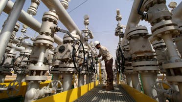 A worker adjusts a valve of an oil pipe in Zubair oilfield in Basra, Iraq July 20, 2017. REUTERS