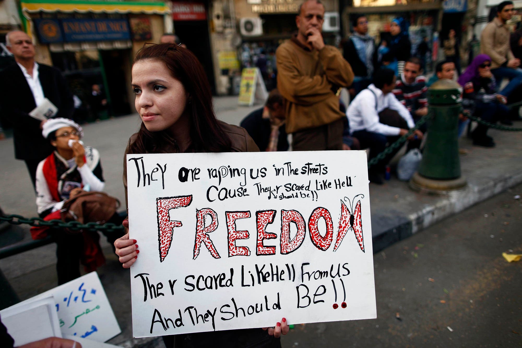 An Egyptian woman holds a banner as she marches in Cairo to mark International Women’s Day on March 8, 2013. (File photo: AFP)