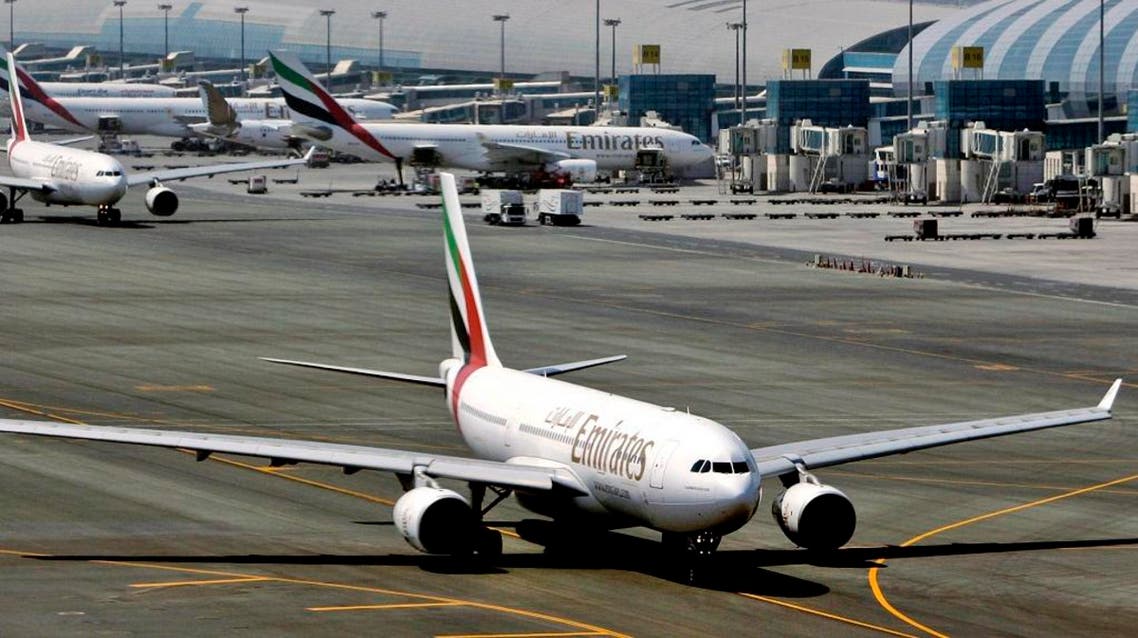 FILE - In April 20, 2010 file photo, an Emirates airline passenger jet taxis on the tarmac at Dubai International airport in Dubai, United Arab Emirates. Emirates said it is suspending flights to Qatar amid a growing diplomatic rift. The airline said on its website Monday, June 5, 2017, that flights would be suspended until further notice starting Tuesday. (AP Photo/Kamran Jebreili, File)