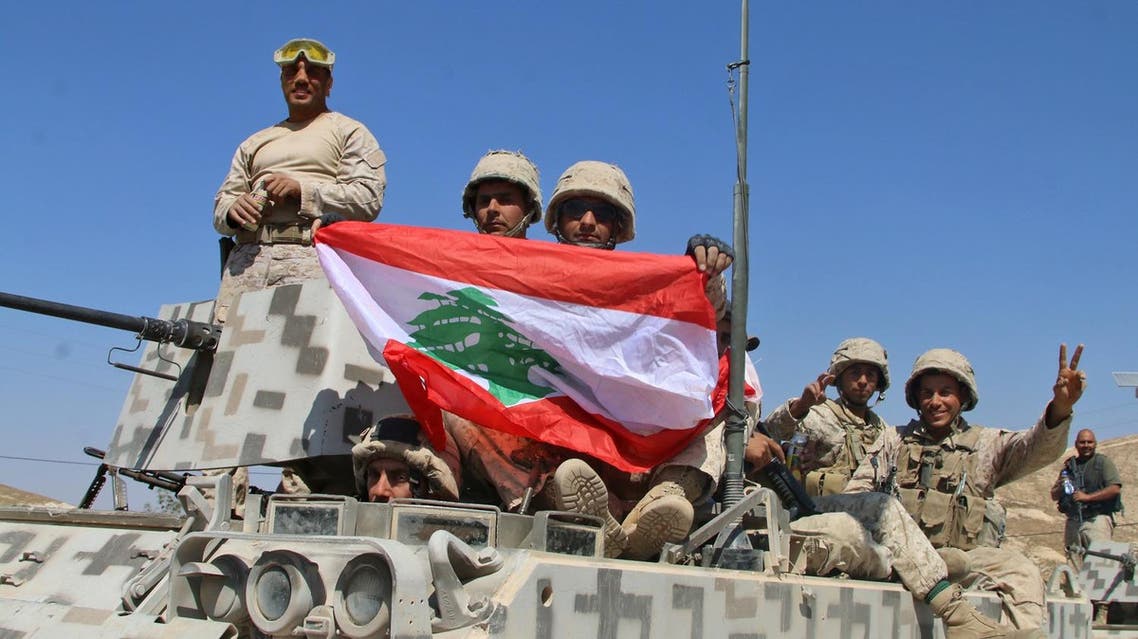 Lebanese army soldiers sit a top an armoured personnel carrier (APC) as they drive in the eastern town of Ras Baalbek, on August 21, 2017, upon returning from the mountainous frontline where an offensive against the Islamic State group on the country's eastern border with Syria after capturing a third of the territory IS held in the region. (AFP)