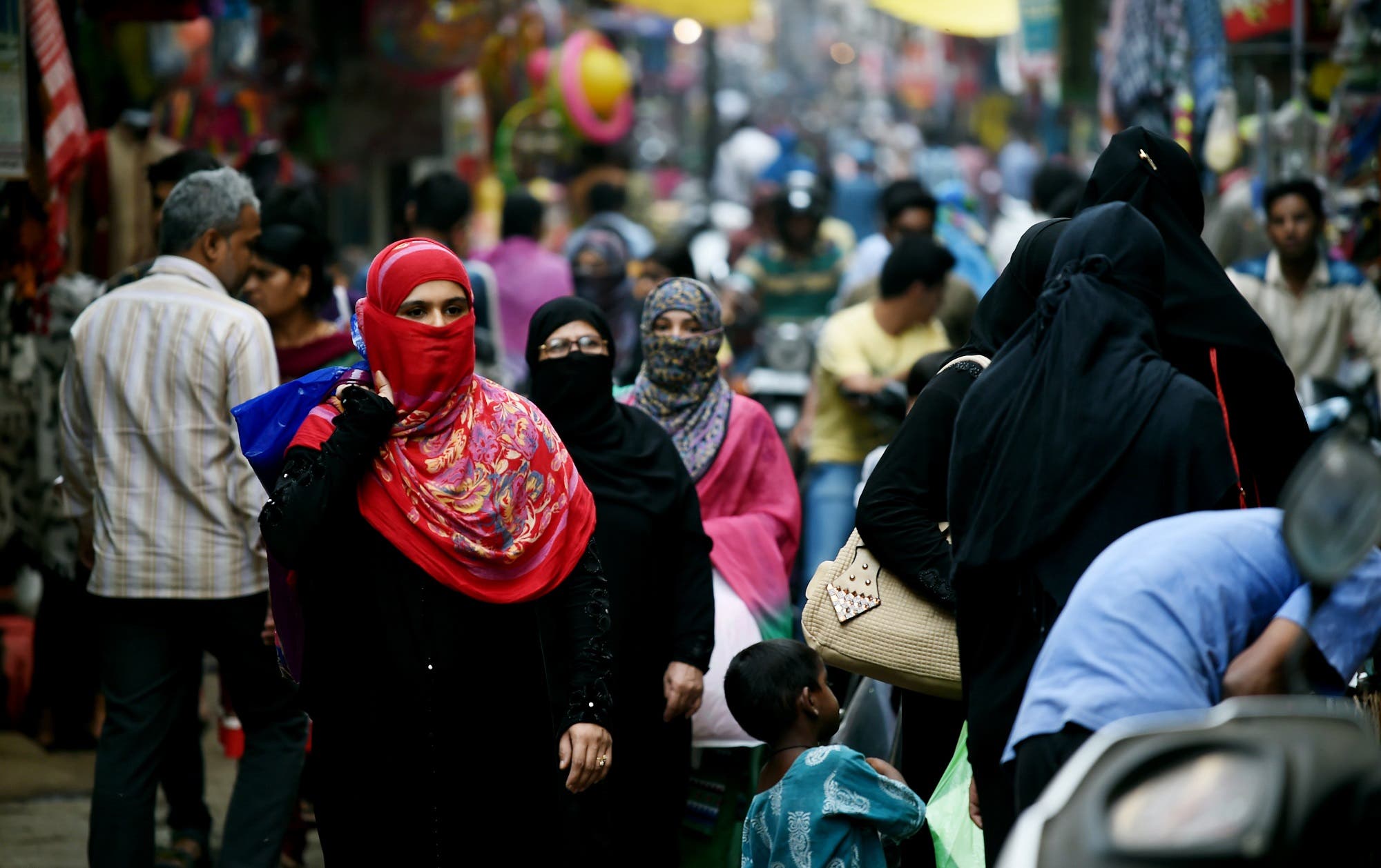 In this photograph taken on April 28, 2016, Muslim shoppers walk through a market in Bhopal. (AFP)