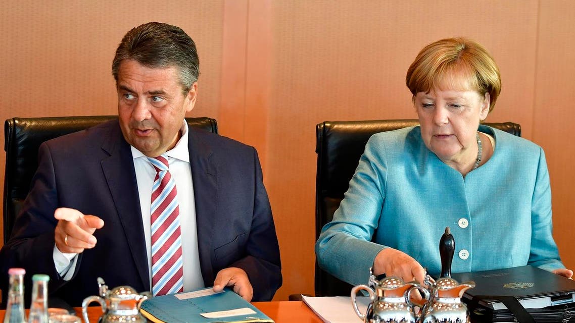 German Chancellor Angela Merkel (R) and German Vice Chancellor and German Foreign Minister Sigmar Gabriel await the start of the weekly cabinet meeting in Berlin, on August 23, 2017. (AFP)