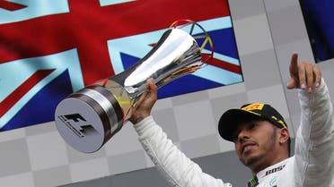 Mercedes driver Lewis Hamilton of Britain raises his trophy in the air on the podium after winning the Belgian Formula One Grand Prix in Spa-Francorchamps, Belgium, on August 27, 2017. (AP)