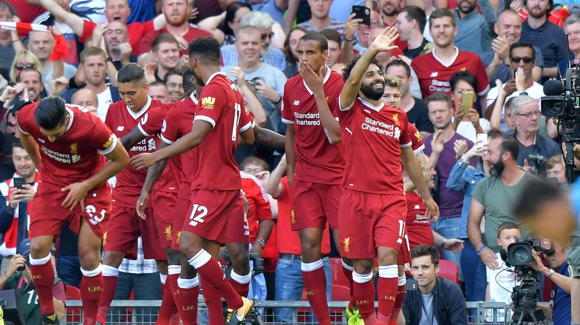 Liverpool's Egyptian midfielder Mohamed Salah (R) celebrates with teammates after scoring their third goal during the English Premier League football match between Liverpool and Arsenal at Anfield in Liverpool, north west England on August 27, 2017. (AFP)