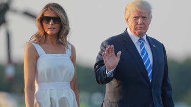 President Donald Trump and first lady Melania Trump walk across the tarmac before boarding Air Force One on August 20, 2017. (AP)