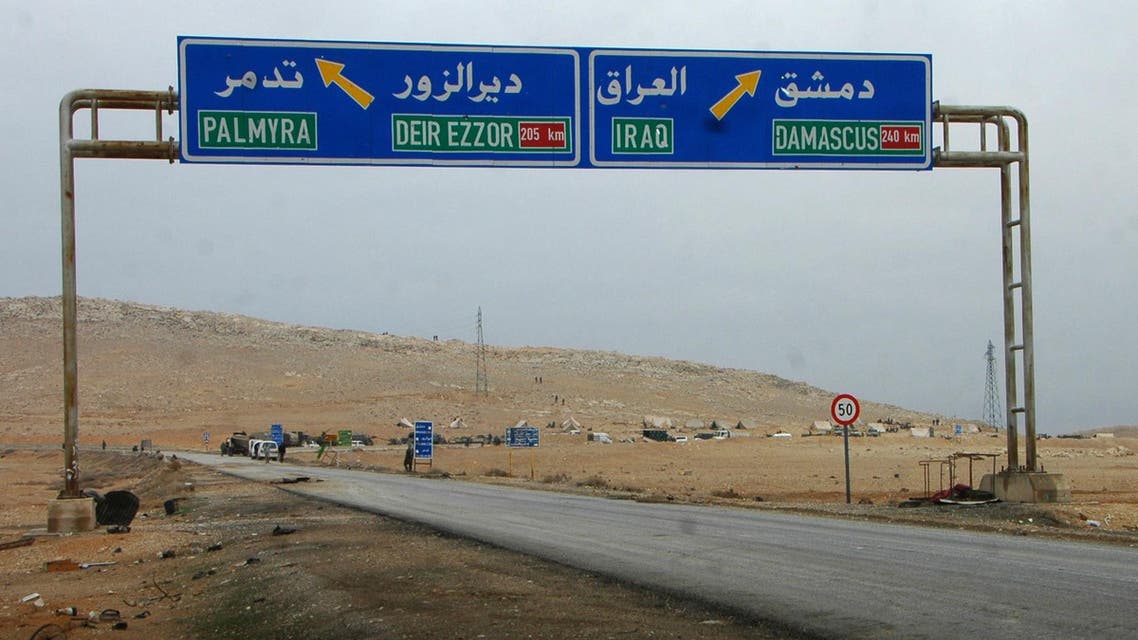 A picture taken on March 2, 2017, shows a sign displaying the routes to Palmyra-Deir Ezzor and Damascus-Iraq as Syrian regime fighters advance to retake the ancient city of Palmyra, from Islamic State (IS) group fighters. STR / AFP