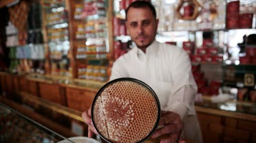 In this Tuesday, Aug. 22, 2017 photo, a Yemeni vendor displays honeycomb for sale in a shop in Sanaa, Yemen. (AP)