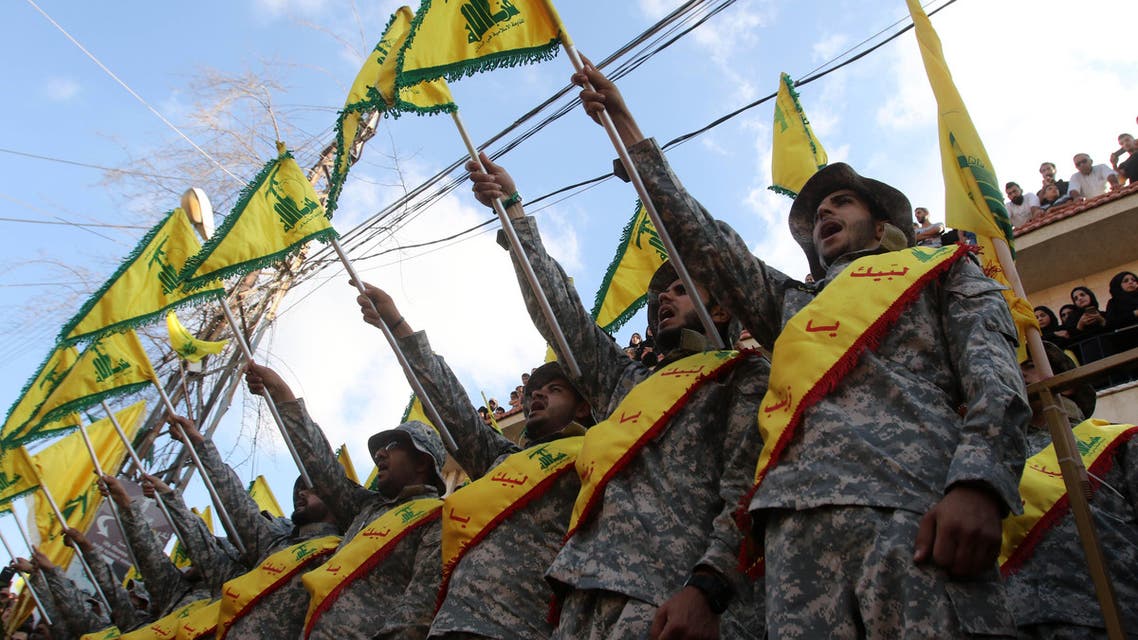 Members of Lebanon's Shiite Hezbollah movement stand at attention during the funeral of a fighter, who was killed in conflict against militant groups in the mountainous area around the Lebanese town of Arsal on the eastern border with war-ravaged Syria, in the southern town of Bisariyeh on August 28, 2017. Mahmoud ZAYYAT / AFP