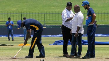 Sri Lanka’s cricket team captain Dinesh Chandimal and chairman of selection committee Sanath Jayasuriya inspect the pitch ahead of their final test match against India. (Reuters)