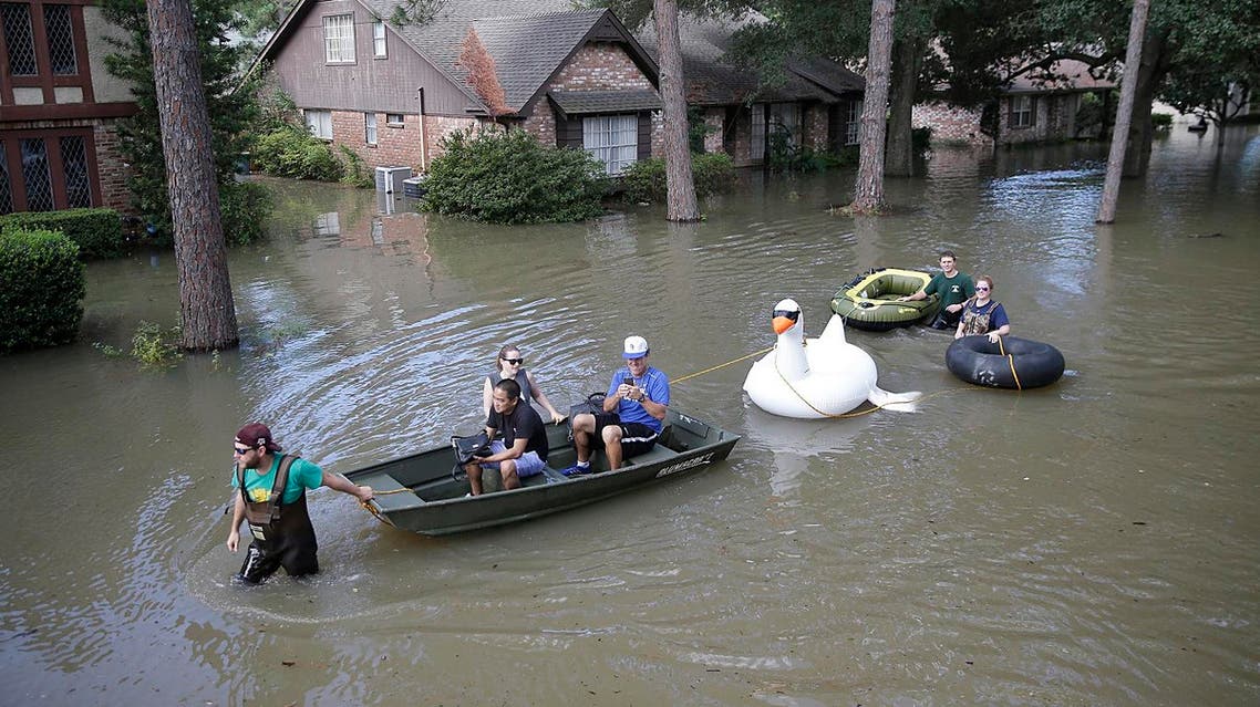 Families evacuate from their homes in Lakeside Estate in Houston, Texas on August 30, 2017.(AFP)
