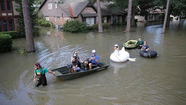 Families evacuate from their homes in Lakeside Estate in Houston, Texas on August 30, 2017.(AFP)