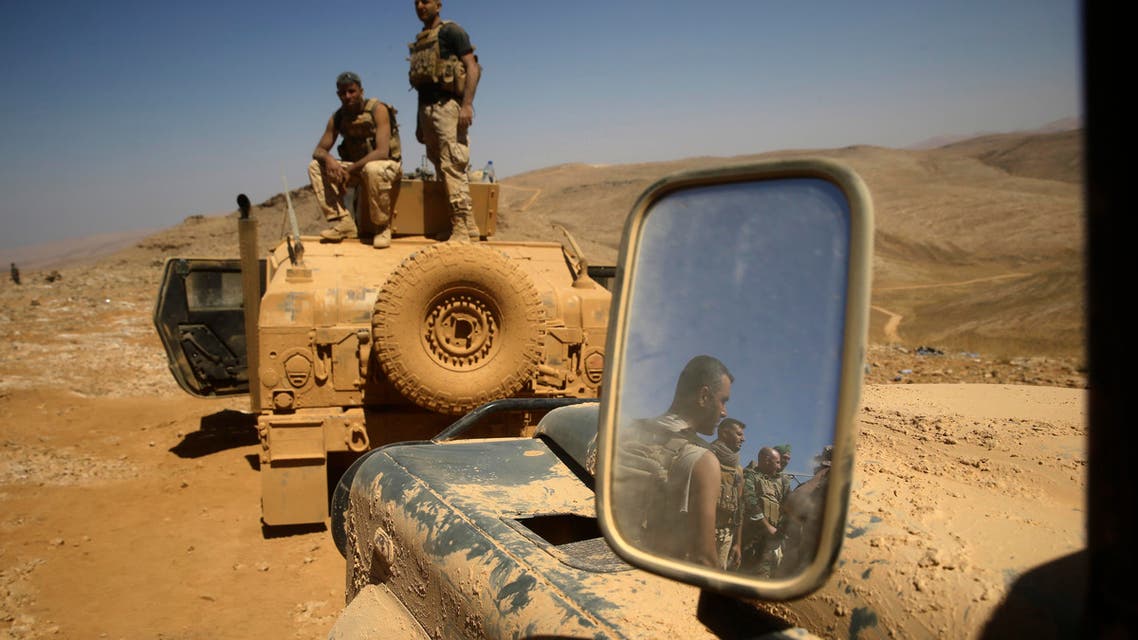 Lebanese soldiers rest on top of an armored personnel carrier during a media trip organized by the Lebanese army, on the outskirts of Ras Baalbek, northeast Lebanon, Monday, Aug. 28, 2017. (ap)