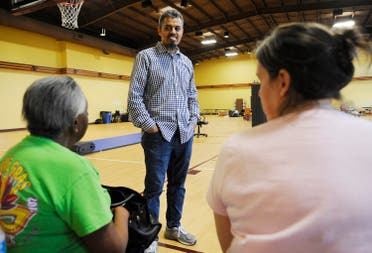 Ayman Kabire, a volunteer at Champions Mosque with the Islamic Society of Greater Houston, talks to evacuees at a mosque that was being used as a shelter. (AP)