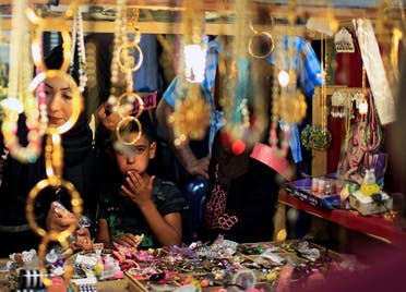 Residents shop in preparation for the Muslim festival of Eid al-Adha in Mosul, Iraq August 31, 2017. (Reuters)